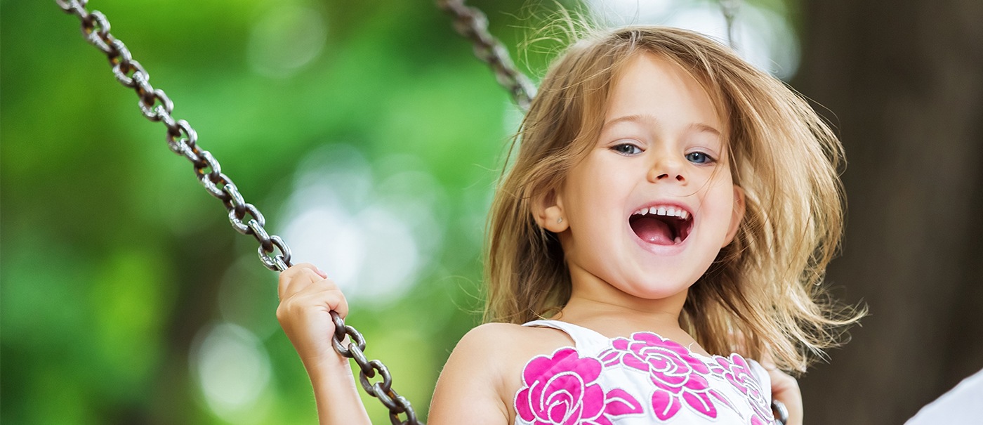Little girl on a swing after children's dentistry visit