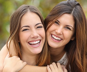 Two women showing off their beautiful smiles
