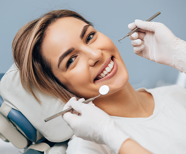 Woman smiling during preventive dentistry exam